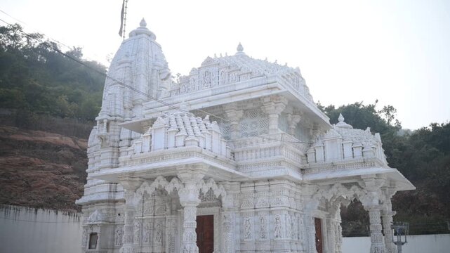 Aerial and ground shots of Lacchuar Jain Temple in Jamui, Bihar showcasing its ancient Jain architecture, serene hilltop setting and peaceful natural surroundings. Clear details, clean lines and herit