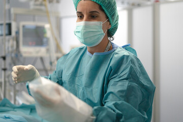 Female surgeon preparing for surgery in operating room