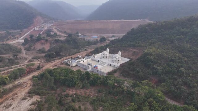Aerial and ground shots of Lacchuar Jain Temple in Jamui, Bihar showcasing its ancient Jain architecture, serene hilltop setting and peaceful natural surroundings. Clear details, clean lines and herit