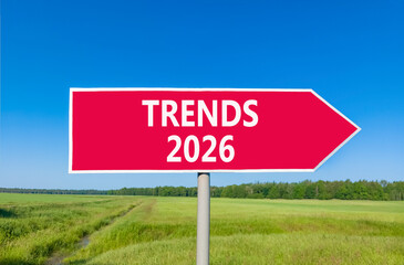 Trends 2026 new year symbol. Concept words Trends 2026 on beautiful red road sign. Beautiful green grass field forest and blue sky background. Business and Trends 2026 new year concept. Copy space.