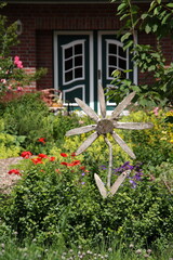 Colorful garden with wooden flower decoration and house