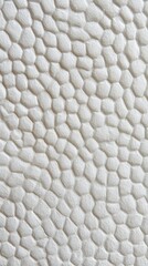 Naklejka premium Textured abstract background featuring a pattern of interlocking hexagons on a soft, light surface, perfect for showcasing modern design elements and minimalistic aesthetics.