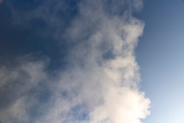 Obraz premium smoke coming from a wide pipe against a sky background, white steam coming from a pipe during heating of a large industrial premises in cold weather