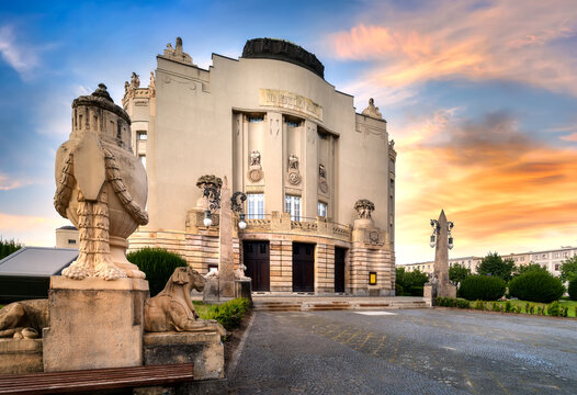 Art nouveau architecture of Cottbus Theater with sculptural details and lawn at sunset