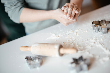 Homemade Christmas Cookies In Preparation: Hands Kneading Dough, Cutting Shapes, And Decorating Biscuits With Chocolate In Cozy Kitchen Atmosphere