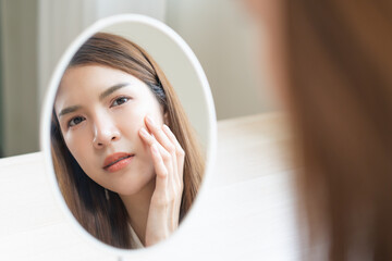 Anti aging, worry puberty asian young woman, stressed girl looking in mirror, allergy presenting an...