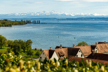 Lake Constance Bodensee in Germany near the city of Hagnau A series of Alpine mountains can be seen in the background photo was taken from the Birnau Church lot Houses, vineyards are visible