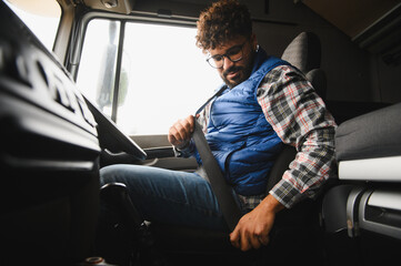 Truck driver fastening seat belt for road safety