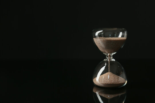 Crystal hourglass on dark  background