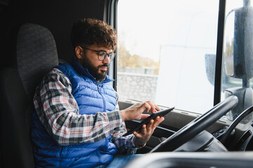 Truck driver using tablet for logistics management