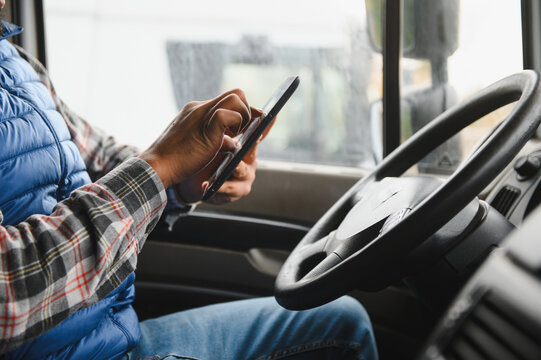 Truck driver distracted by texting on smartphone - Powered by Adobe
