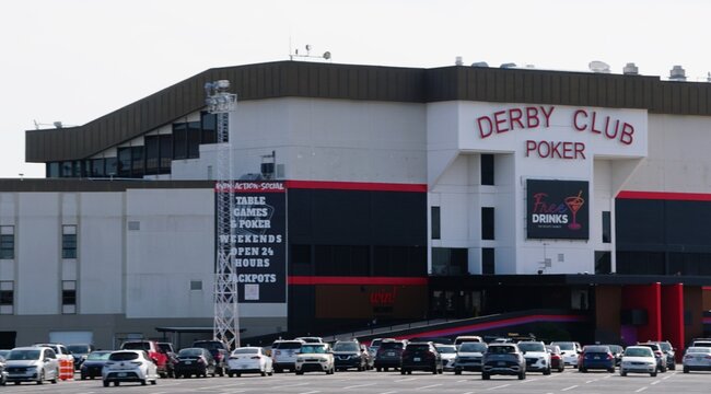 St Petersburg, Florida, U.S - Nov 9, 2025 - Exterior view of the Derby Club Poker facility, featuring a large parking area filled with vehicles.