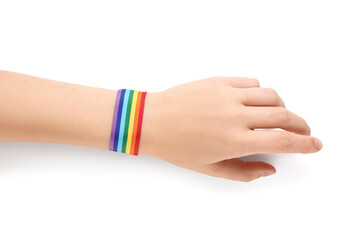 Female hand with rainbow ribbon on white background. LGBT concept