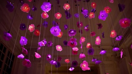 Creative remotecontrolled flowers dancing softly in an event space adding a whimsical and interactive floral experience to social gatherings