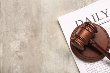 Judge's gavel with newspaper on grunge background