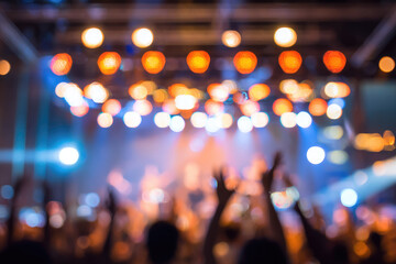 Blurred crowd cheering under vibrant stage lights at live music concert, creating energetic and festive atmosphere with colorful neon illumination and raised hands