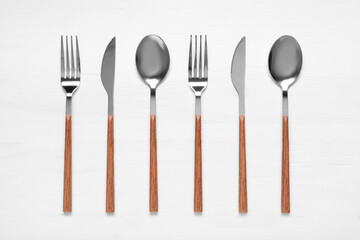 Cutlery on white wooden background
