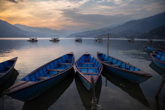 Blue Wooden Boats on Lake Phewa at Sunset, Pokhara, Nepal - Powered by Adobe