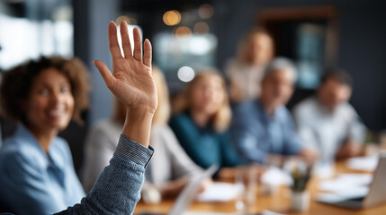 Diverse business team in meeting room with hand raised for question faceless participants defocused conference background strategic planning session collaborative environment