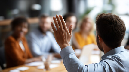 Diverse business team in meeting room with hand raised for question faceless participants defocused conference background strategic planning session collaborative environment