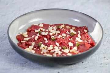 Beef Carpaccio cold appetizer with parmesan