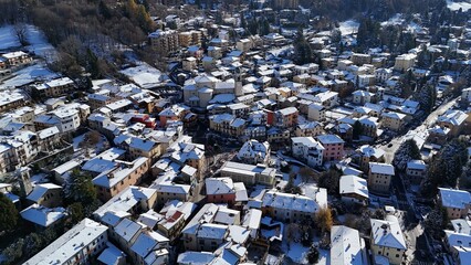 Aerial drone view of snowy Barzio village in Valsassina, Lombardy, Italy