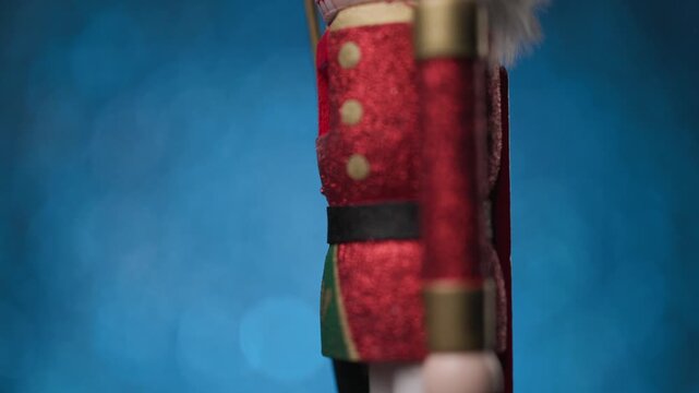 Dynamic motion of the Toy Nutcracker against a lively blue bokeh background, closing with a face-focused close-up