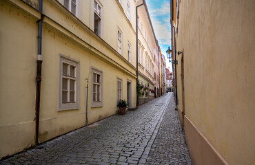 Prague, Czech Republic, August 9, 2023. A charming cobblestone alley in the Old Town. Perspective view. Travel destinations.