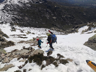 Man with his son walking across snowy terrain