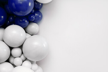 Blue and white balloon garland on a clean white background, festive decorative backdrop ideal for celebrations, parties, and event design.