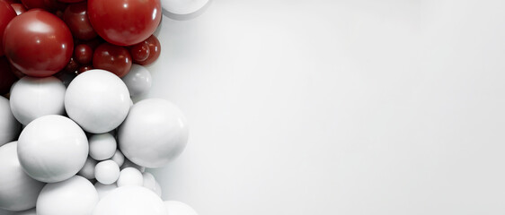 Minimalist balloon arrangement with red and white balloons on a clean white background, creating modern party decor and copy space for celebration designs.