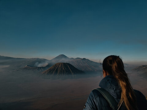 Woman enjoying sunrise at Mount Bromo in Indonesia