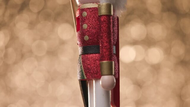 Toy Nutcracker spins gracefully against a vibrant golden bokeh background, ending with a close-up of its head
