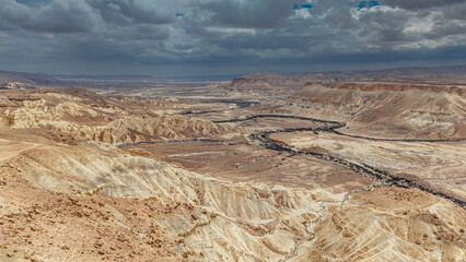 A scenic landscape captured in the Ein Avdat desert canyon region, showcasing dramatic cliffs, natural rock formations, and the unique textures of the Negev landscape. The still image highlights the s © Arthur