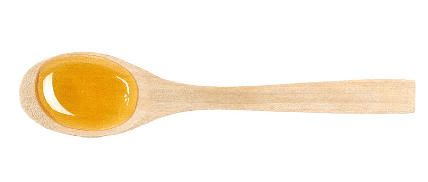 Honey in wooden  spoon isolated on white background, top view