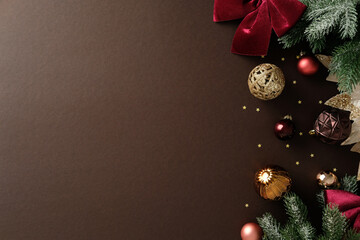 Christmas greeting card design. Xmas border with velvet poinsettia, fir branches, and baubles on...