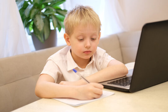 Young boy studying online with laptop remote learning