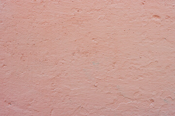 Old pink concrete wall close-up.
