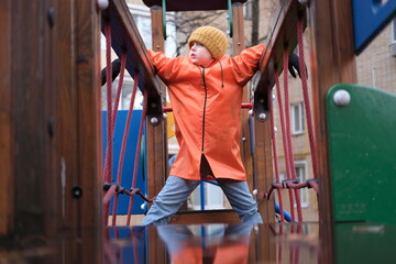 Young boy exploring playground obstacle course