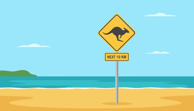 Kangaroo warning sign on sandy beach against ocean background  