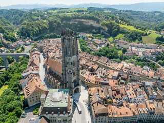 Aerial view of St Nicolas Cathedral in old town of Fribourg. Medieval church with large tower in Europe.
