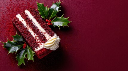 Festive red velvet cake piece with holly decoration on textured red surface