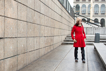 The contrast between her fiery red hair and Madrid's classic architecture is accentuated by her...