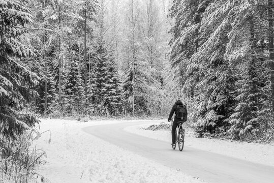 Beautiful winter snowy landscape with a cyclist. Oulu has an excellent cycling infrastructure, the best in Finland. People ride bicycles in all seasons. Oulu is the European Capital of Culture 2026.