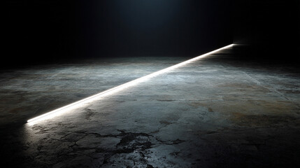 Diagonal light streak crossing a dark floor creating a dramatic contrast that symbolizes direction clarity momentum and the subtle emergence of insight within a minimalist shadowed space