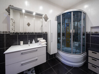 Bathroom in the apartment. Shower stall and bathtub.