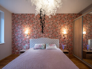 The bedroom in the apartment is in colorful bright red tones.