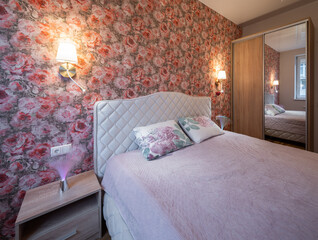 The bedroom in the apartment is in colorful bright red tones.