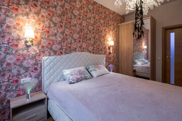 The bedroom in the apartment is in colorful bright red tones.