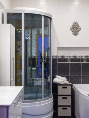 Bathroom in the apartment. Shower stall and bathtub.